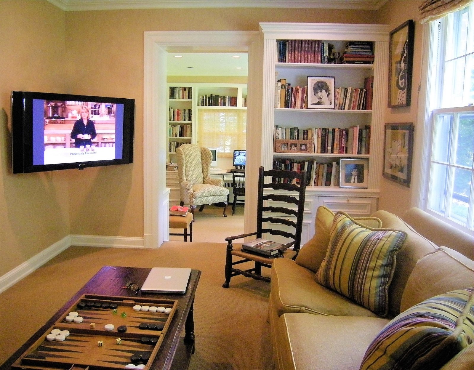 Family room with built-in bookshelves, a games table, and a wall-mounted television