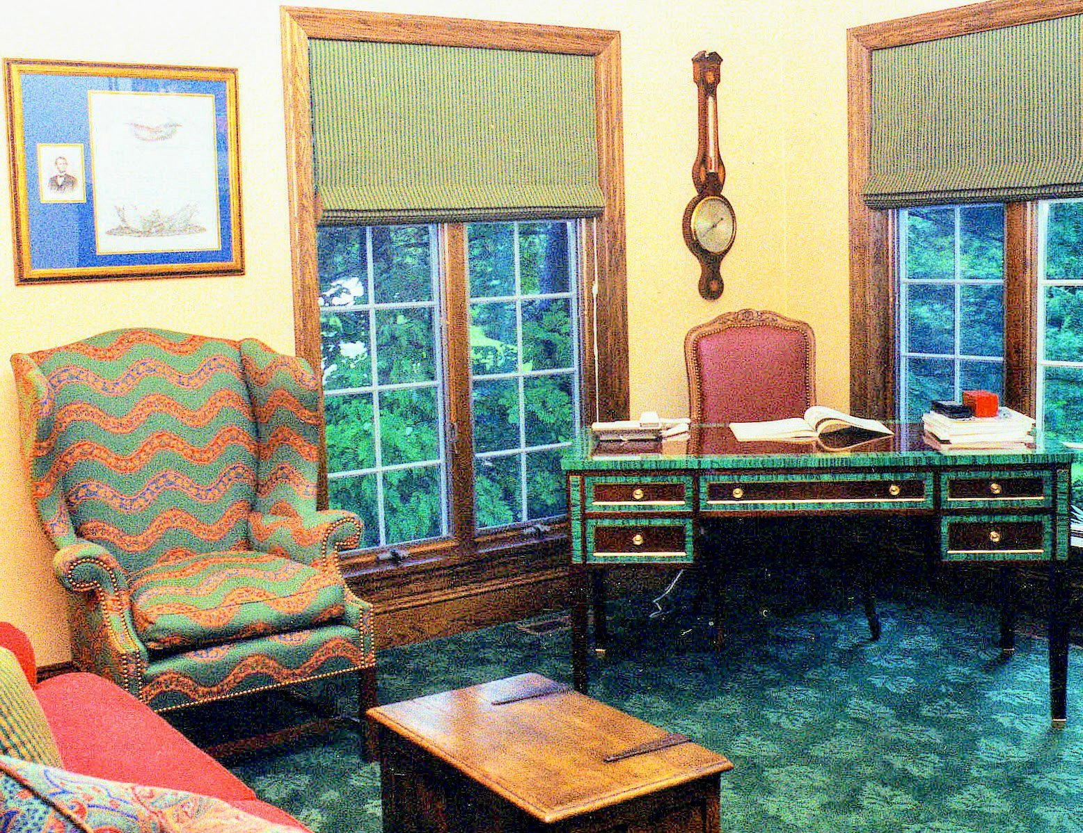 Study with a malachite writing desk, a needlepoint wing chair, and an emerald carpet
