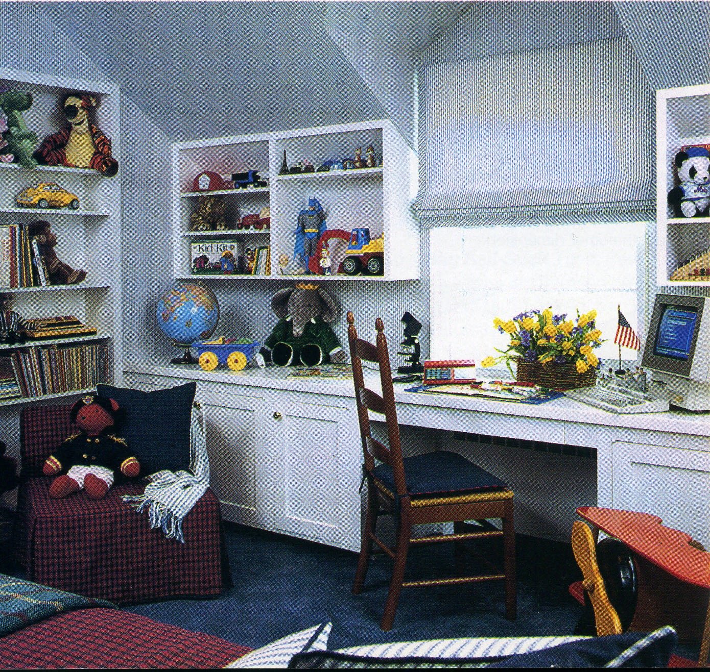 Children's room with white built-ins, a study desk, a globe, and shelves of toys