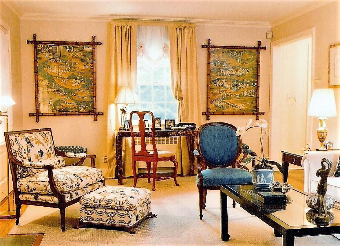 Classic living room with chinoiserie panels in bamboo frames and blue and floral upholstery
